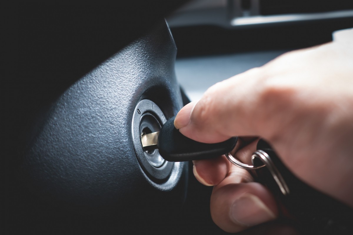 hand turning key in ignition